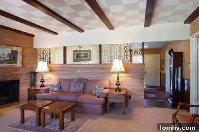 The living room of the house before its modern makeover, showing the original layout and fireplace.