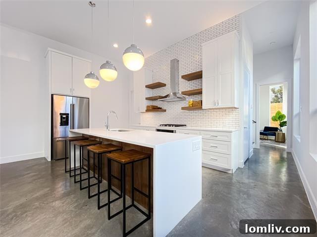 Gourmet kitchen with waterfall island and high-end appliances in the Oak Lawn area home.