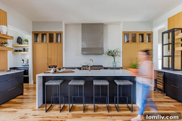 2021 Interior Design Forecast 5 Modern kitchen with warm natural wood cabinetry and rustic overhead beams.