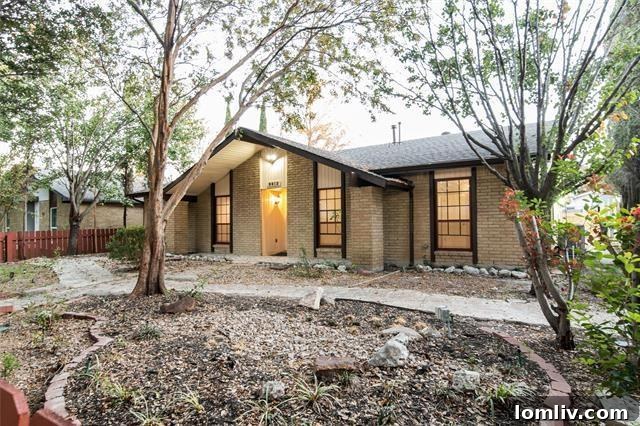Spacious kitchen with granite countertops, wooden cabinetry, and stainless steel appliances
