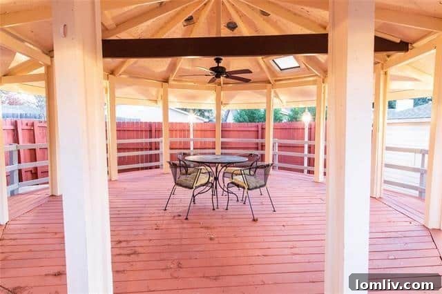 Expansive covered patio with a wooden gazebo, perfect for outdoor entertaining and relaxation