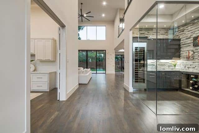 Dramatic open-tread staircase with glass railing in a luxury Dallas residence
