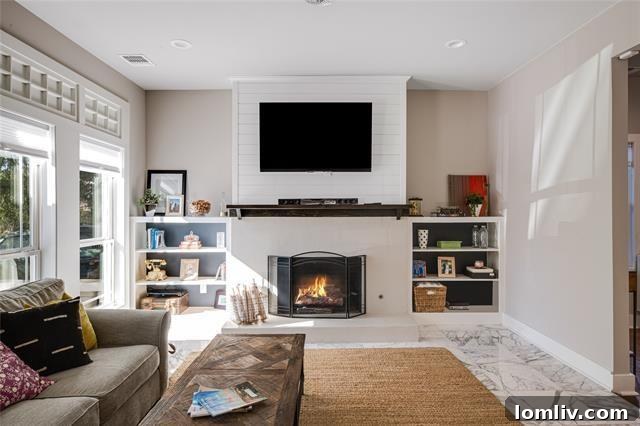 Bright open concept living and dining area with hardwood floors in a Dallas craftsman