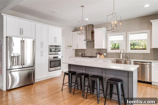 Modern chef's kitchen with stainless steel appliances, white cabinetry, and subway tile backsplash