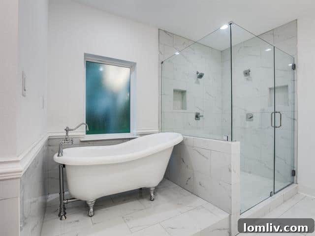 Spa-like primary bathroom with elevated clawfoot tub