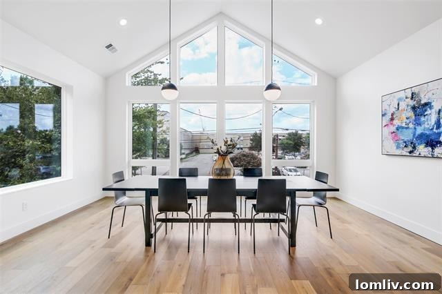 Spacious open-concept living area with high vaulted ceilings, large windows, and contemporary furnishings, perfect for entertaining