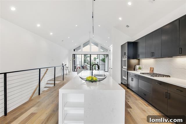 A view of the living room connecting to the kitchen, showing the seamless open flow and abundant natural light