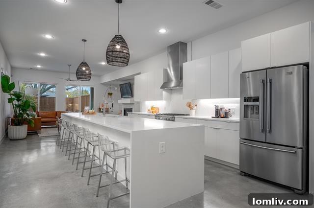 Gourmet kitchen with an oversized quartz island, custom cabinetry, and high-end appliances, perfect for entertaining.