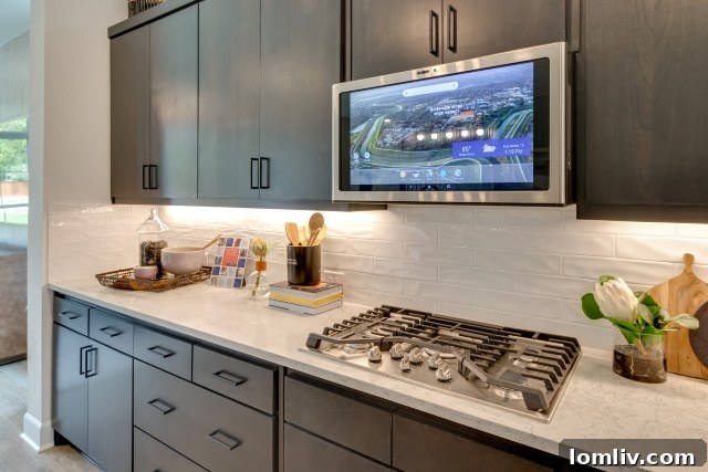 Modern kitchen with gas appliances and sleek integrated vent hoods in Edgewater