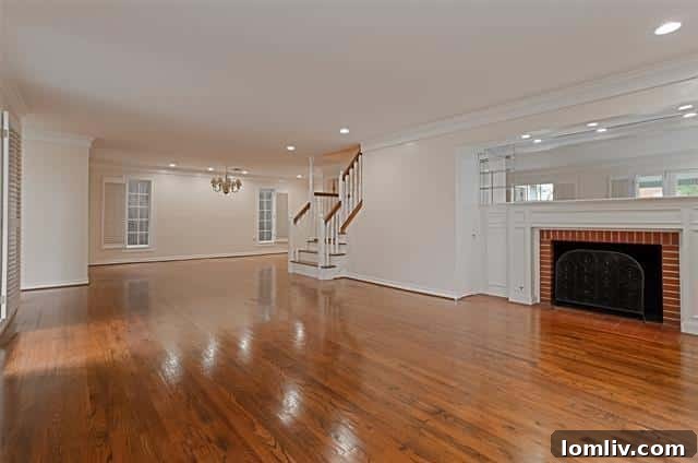 Inviting all-white kitchen with ample counter space and butler's pantry access