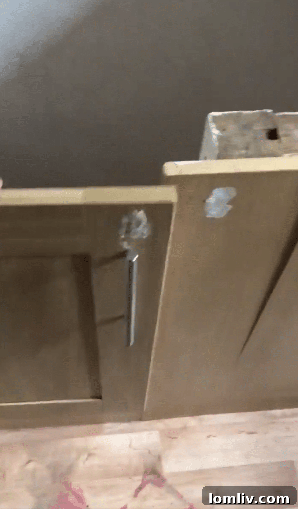 Screenshot: The hidden door under the kitchen counter, slightly ajar