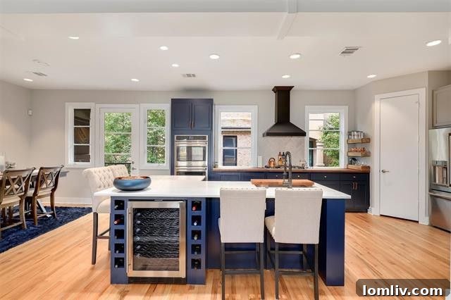 Modern kitchen with a large center island, wine fridge, and stainless steel appliances in the affordable Oak Lawn condo