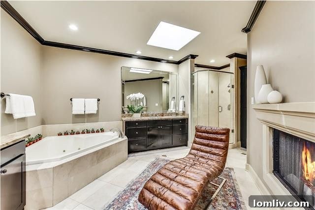 Luxurious master bedroom featuring a see-through fireplace and elegant furnishings in a high-end Dallas townhome