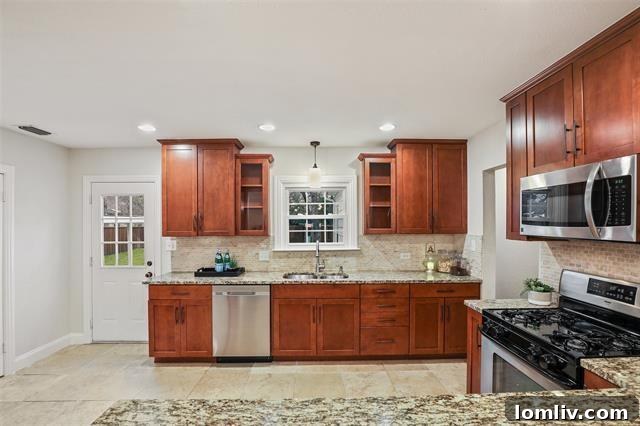 Lush Living at Casa Linda: A Fully Upgraded Cottage Retreat 6 The custom granite kitchen in this Casa Linda cottage features a gas stove, stainless steel appliances, and ample storage, perfect for any home chef.