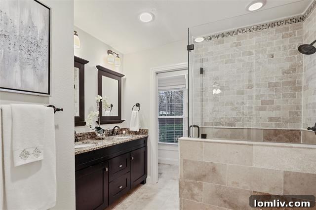 Lush Living at Casa Linda: A Fully Upgraded Cottage Retreat 8 The newly renovated master bedroom in this Casa Linda cottage offers an inviting ensuite bath with a spacious shower and double sinks, a true sanctuary.