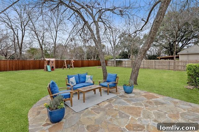 Lush Living at Casa Linda: A Fully Upgraded Cottage Retreat 9 Discover the perfect outdoor oasis in this Casa Linda home's park-like backyard, featuring a stone patio, vast lawn, and ample space for gardening and play.