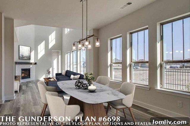 Spacious open-concept kitchen and living area rendering in the Craftsman Cottage, flooded with natural light