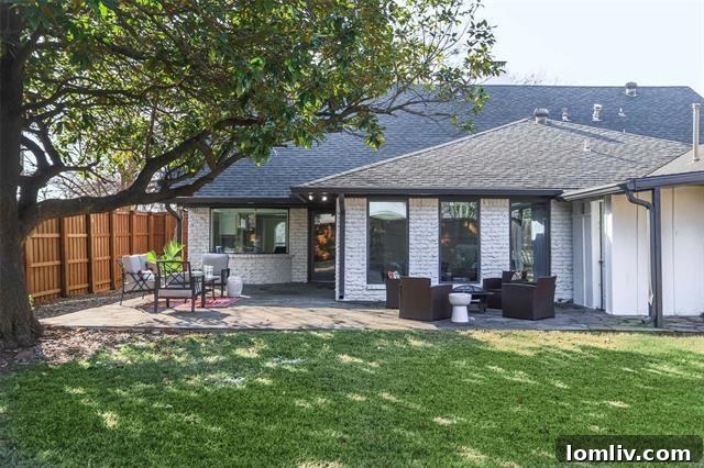 Oversized backyard with covered patio and flagstone deck for entertaining