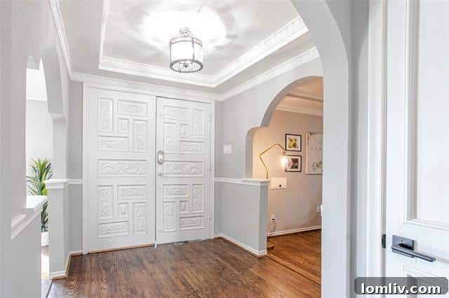 Spacious open-concept living area with vaulted ceilings and wood floors