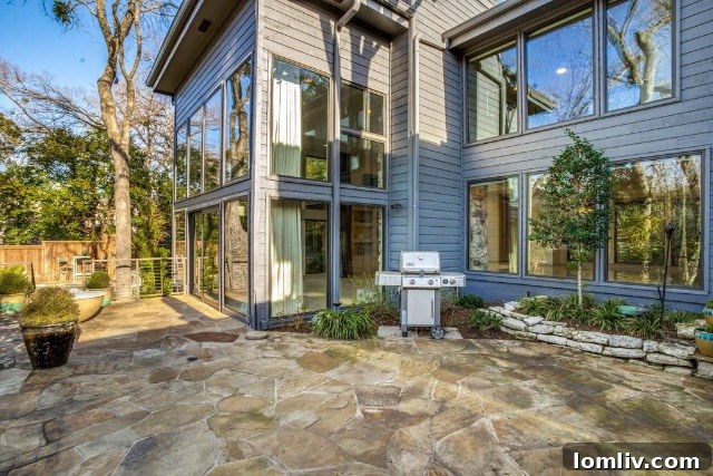 Architectural detail of the home's exterior with stone elements and expansive windows