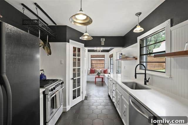 The newly updated kitchen of the Hollywood Heights home, showcasing modern quartz countertops, black hexagon floor tiles, and stylish floating shelves, designed for both beauty and culinary function.