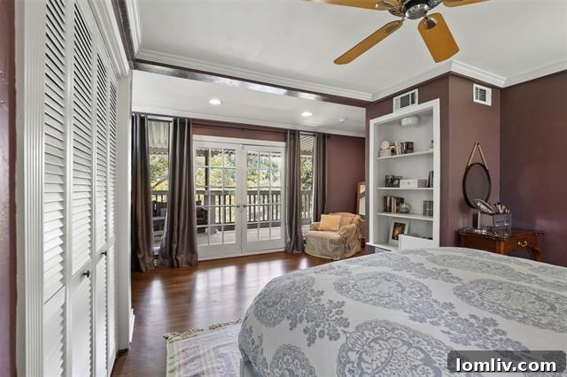 The serene master bedroom of the Hollywood Heights residence, featuring French doors that open to a large covered balcony, creating a luxurious and private retreat.