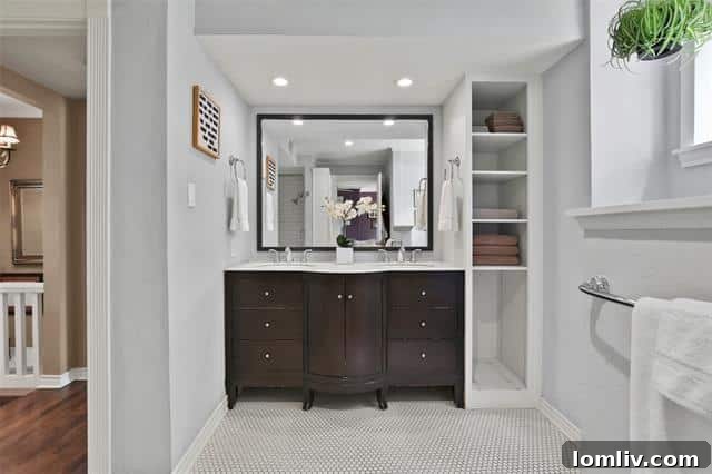 A bright and airy master bathroom, featuring stylish penny tiles, double sinks, and a convenient shower-tub combination, designed for modern comfort and elegance.