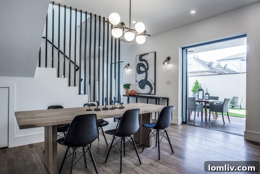 Modern dining area with large windows connecting to an outdoor patio