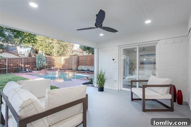 Inviting swimming pool and covered patio in the backyard of 9805 Estate Lane