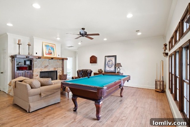 Vibrant game room featuring a fireplace and billiards table at 313 North Bailey Drive, perfect for entertaining. Note: Be careful not to hit the fireplace with your pool cue!