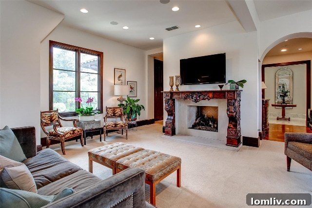 Exquisite fireplace with an intricately hand-carved mantel in the luxurious master suite of 44 Valley Ridge Road.