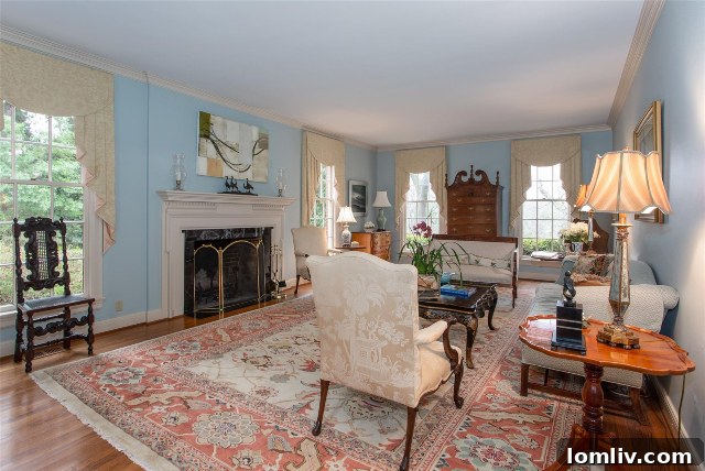 Elegant fireplace with a decorative mantel in the formal living room of 43 Valley Ridge Road, Westover Hills.