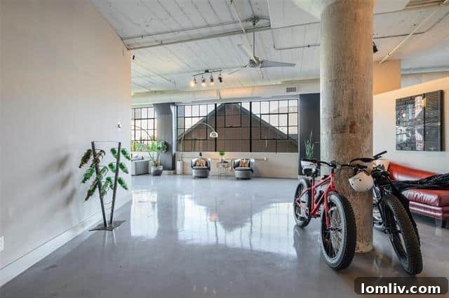 A modern kitchen with a large island and designer appliances in a Dallas loft