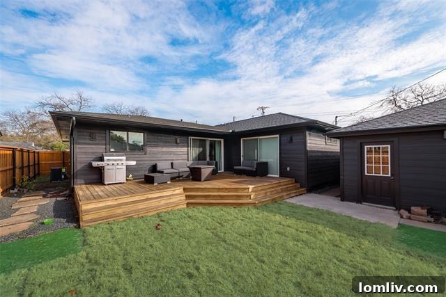 Expansive fenced backyard with large deck