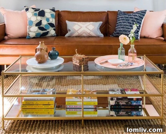 Glass-topped cocktail table displaying an aesthetically pleasing mix of books and accessories