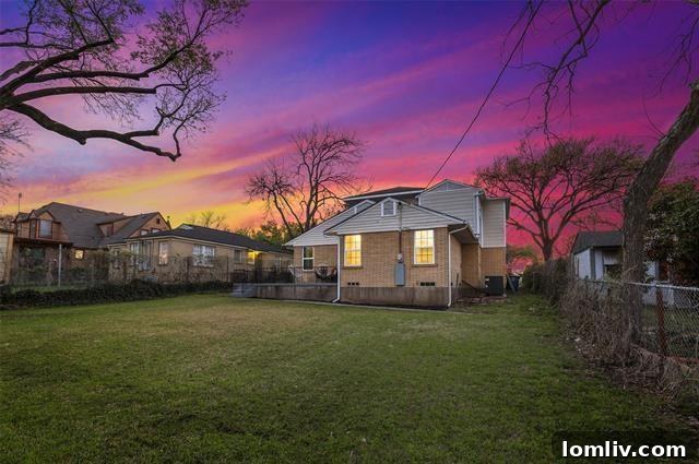An inviting backyard landscape with ample green space, perfect for family activities and outdoor gatherings.