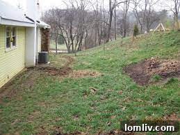 Slope around a house indicating drainage needs