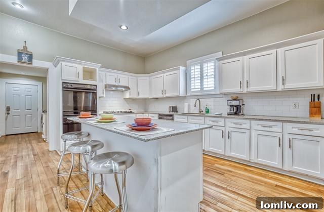 Spacious Kitchen with Large Center Island and White Cabinetry