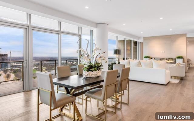Luxurious master bedroom in a Plano condo with expansive city views, a seating area, and sophisticated design.