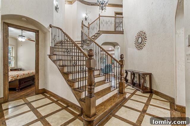 Grand entrance and foyer of a Fort Worth Montserrat home, showcasing traditional architectural details and an elegant staircase.