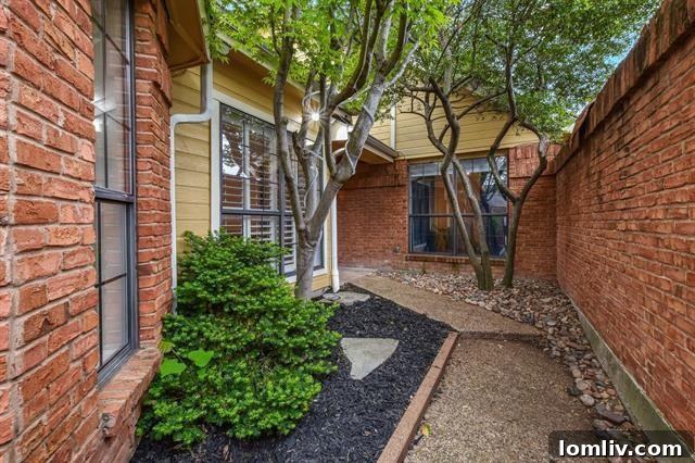 Bright, Bold, and Beautiful: This North Dallas Gem Features Soaring Ceilings, Abundant Light, and Distinctive Architecture 8 Welcoming Front Entrance with Flagstone Path and Wrought Iron Gate