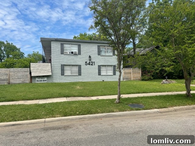 Multi-family complex facing a significant historic home on Swiss Avenue.