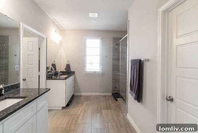Luxurious master bathroom with a huge shower, separate vanities, and a modern color palette.