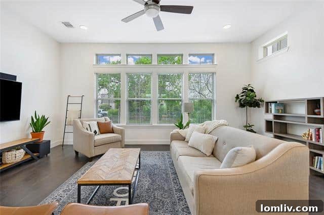 Spacious open-concept living area with high ceilings, modern decor, and abundant natural light.