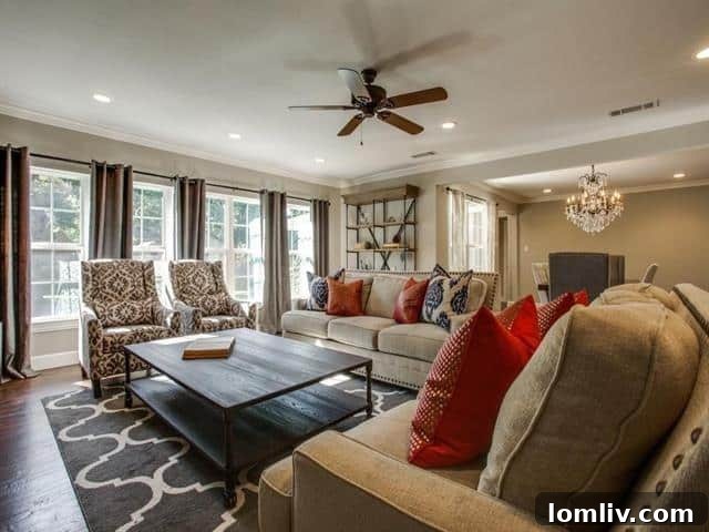 A bright and inviting living room featuring hand-scraped hardwood floors, ample natural light, and a modern, neutral color palette.