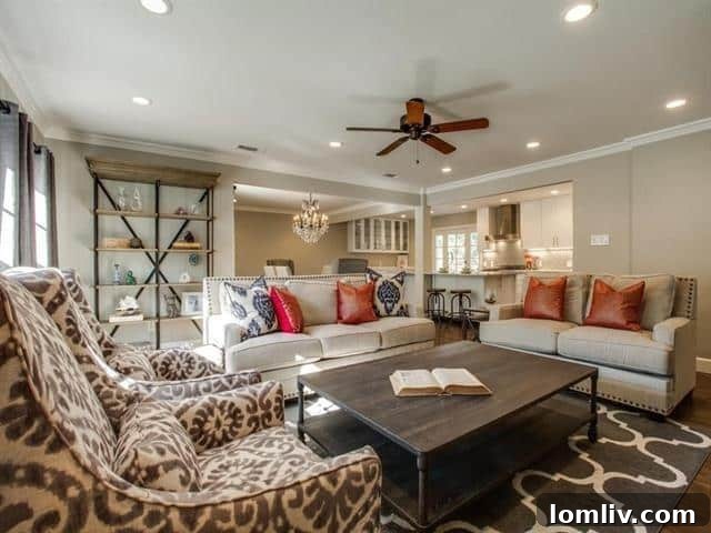 Another view of the living area, showcasing an open-concept layout and the elegant flow of the hand-scraped hardwood floors throughout the space.