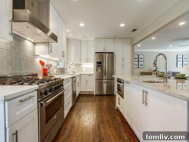A wider shot of the gourmet kitchen, highlighting the spacious center island perfect for meal prep and casual dining, with direct outdoor access.