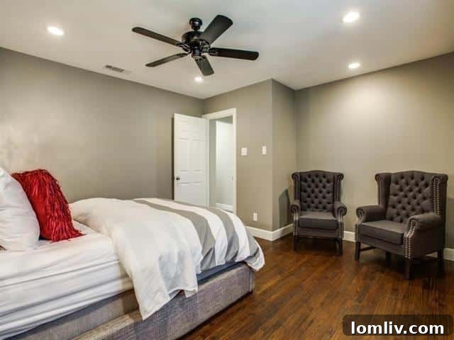 A spacious and serene master bedroom, featuring a dedicated sitting area and ample natural light.