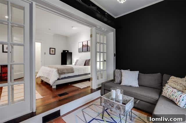 Cozy Master Bedroom with French Doors Leading to a Sunroom