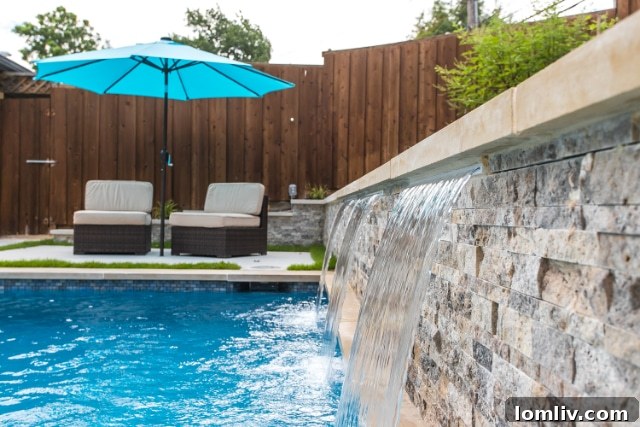 Pool Construction Reimagined 5 An expansive backyard oasis featuring a custom pool, outdoor kitchen, and fireplace.